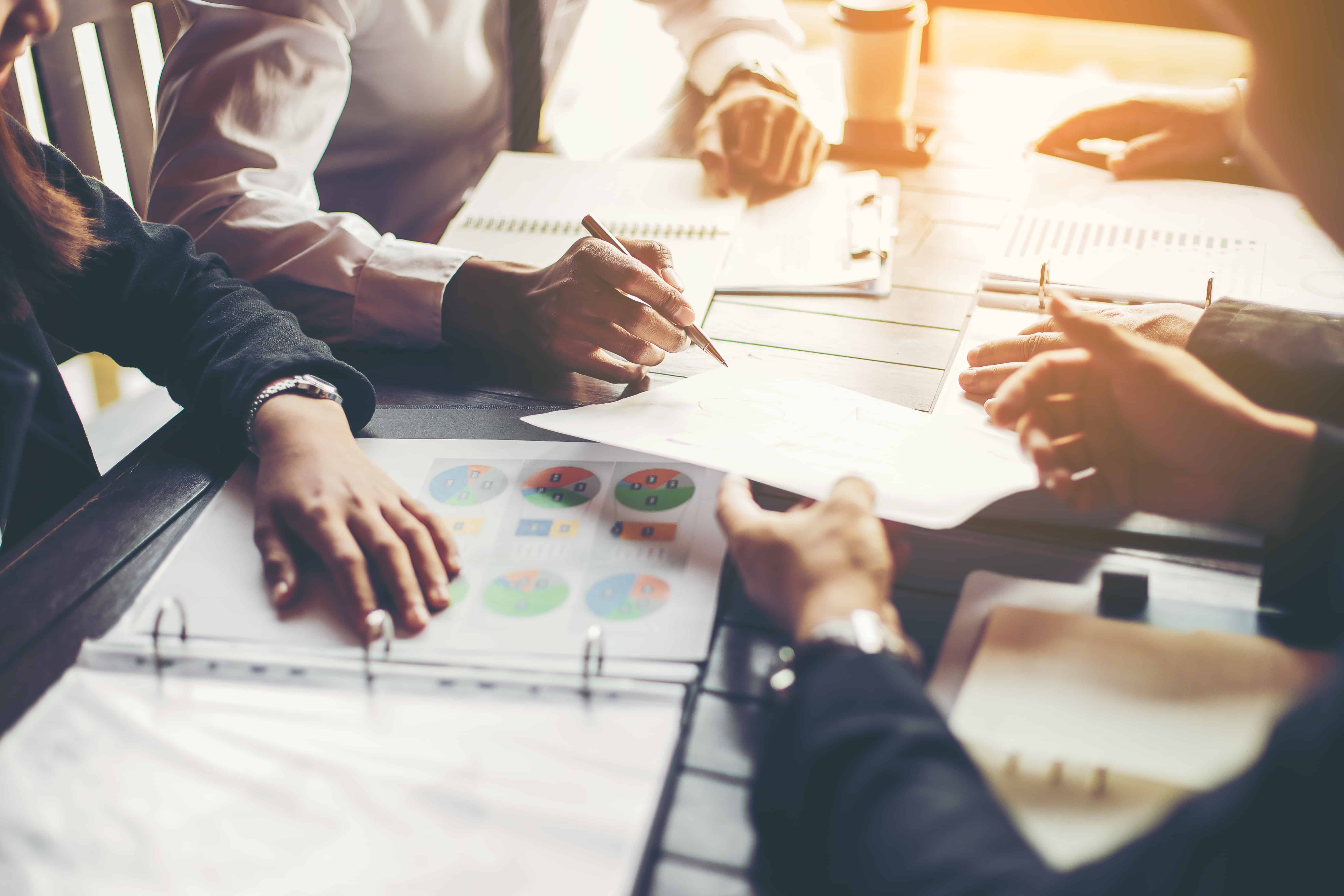 Group of people in a meeting looking at documents